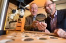 Associate Professor Kenneth Sheedy and Dr Gil Davis examine ancient coins.