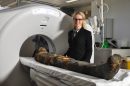 Dr Ronika Power examining a mummified human body from the Australian Museum’s Egyptian Collection, at Macquarie Medical Imaging, Macquarie University Hospital