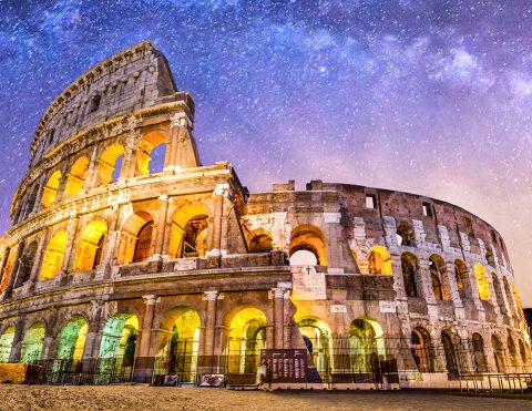 front view of Coliseum of Rome at night with the milky way. Italy